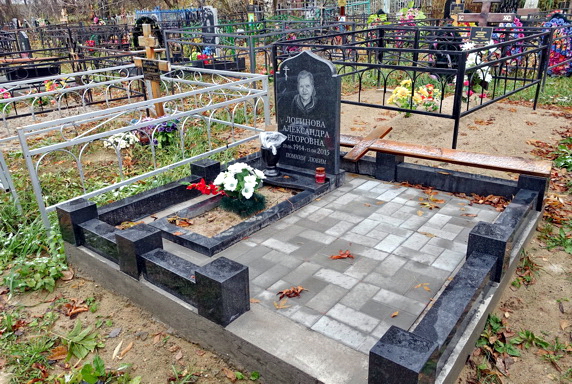 Простой невысокий памятник из гранита на бетонном основании
